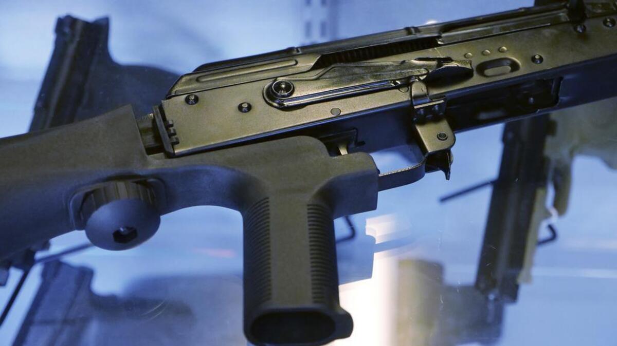 A device called a “bump stock” is attached to a semi-automatic rifle.