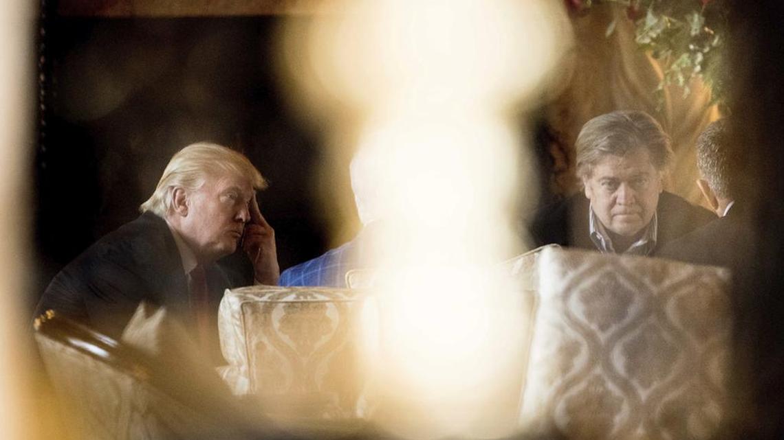President-elect Donald Trump, left, and chief strategist Steven Bannon, right, attend a meeting at Mar-a-Lago, in Palm Beach, Fla., in December.