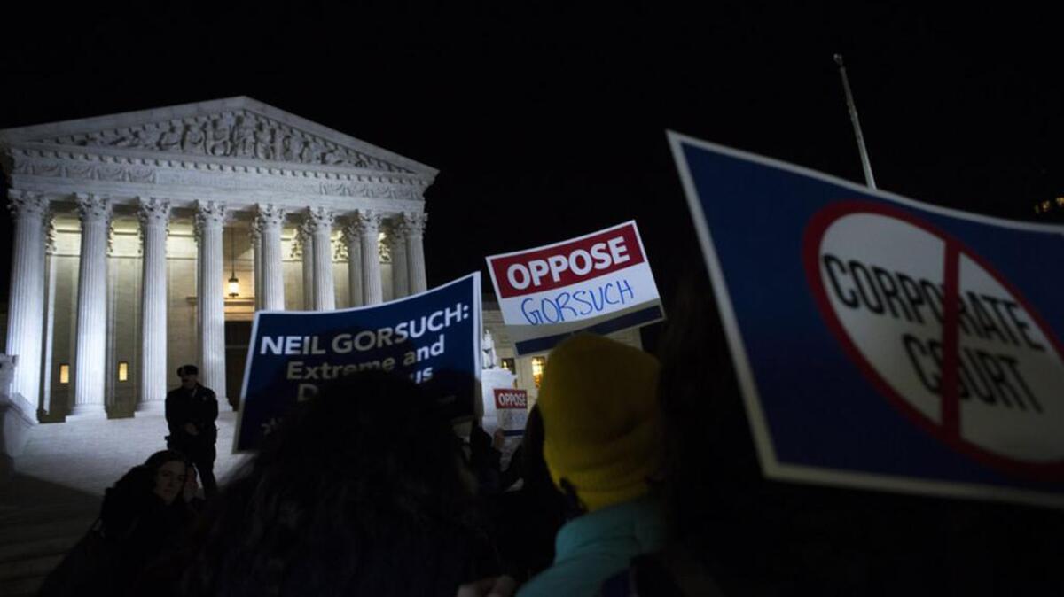Protesters demonstrate at the US Supreme Court Building after President Donald Trump announced Judge Neil Gorsuch as his nominee for the vacant seat.