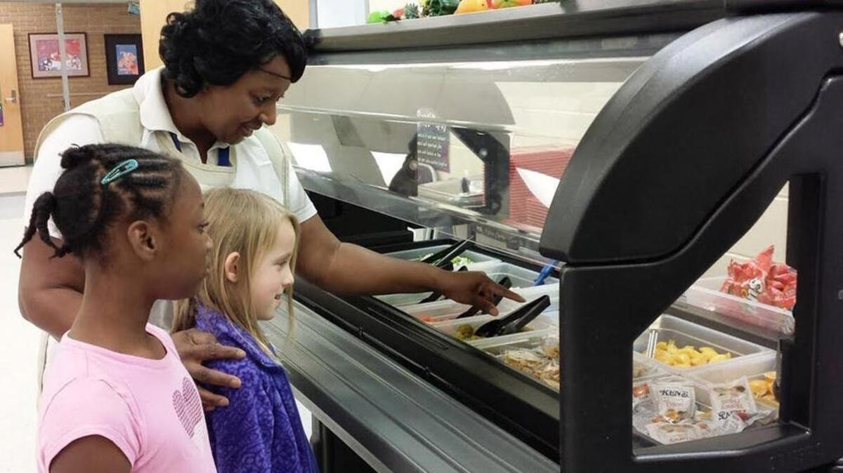 Brockman cafeteria manager Shirleen McCrea shows students the healthy selections in the school’s salad bar. Richland 1 Provided photo