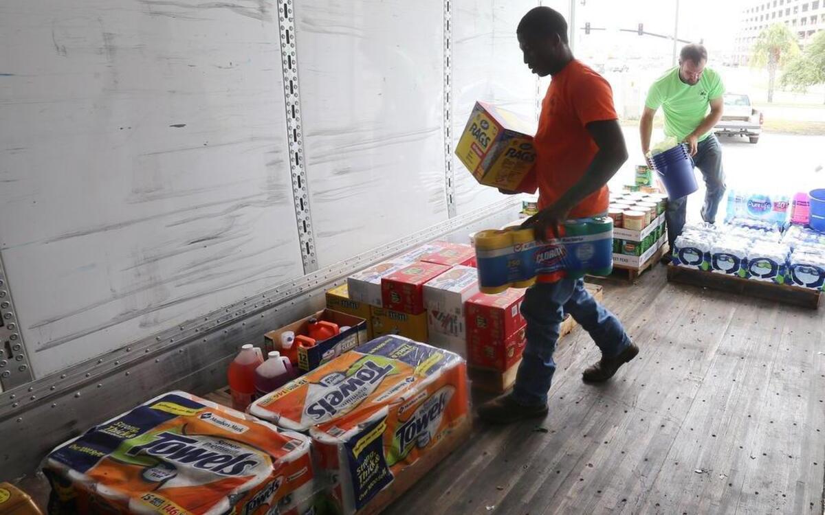 Mario Shade of Wiggins and Clint Ireland of Perkinston, Louisiana, organize donated hurricane relief supplies for Hurricane Harvey victims.