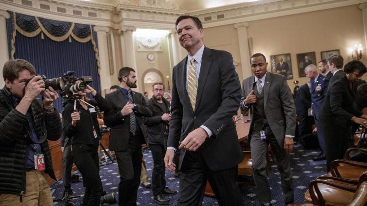 Then-FBI Director James Comey takes a break after three hours of testifying in march before the House Intelligence Committee hearing on allegations of Russian interference in the 2016 US presidential election.