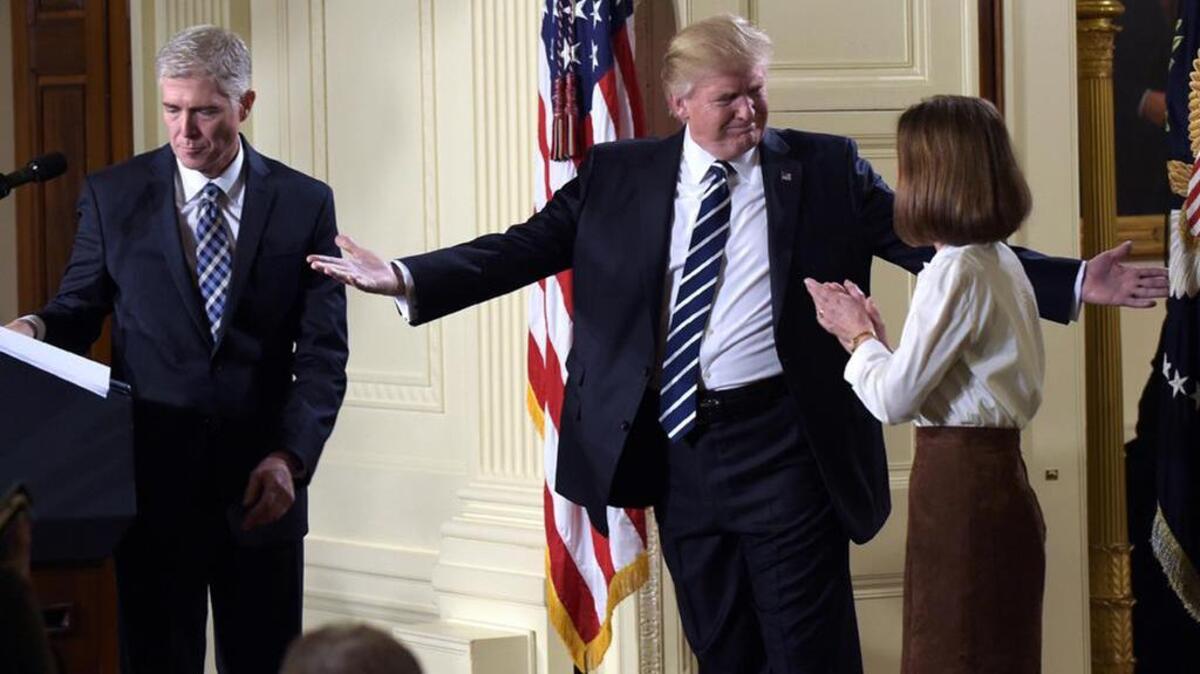 President Donald Trump gestures toward Louise Gorsuch after announcing 10th U.S. Circuit Court of Appeals Judge Neil Gorsuch as his choice for the Supreme Court.