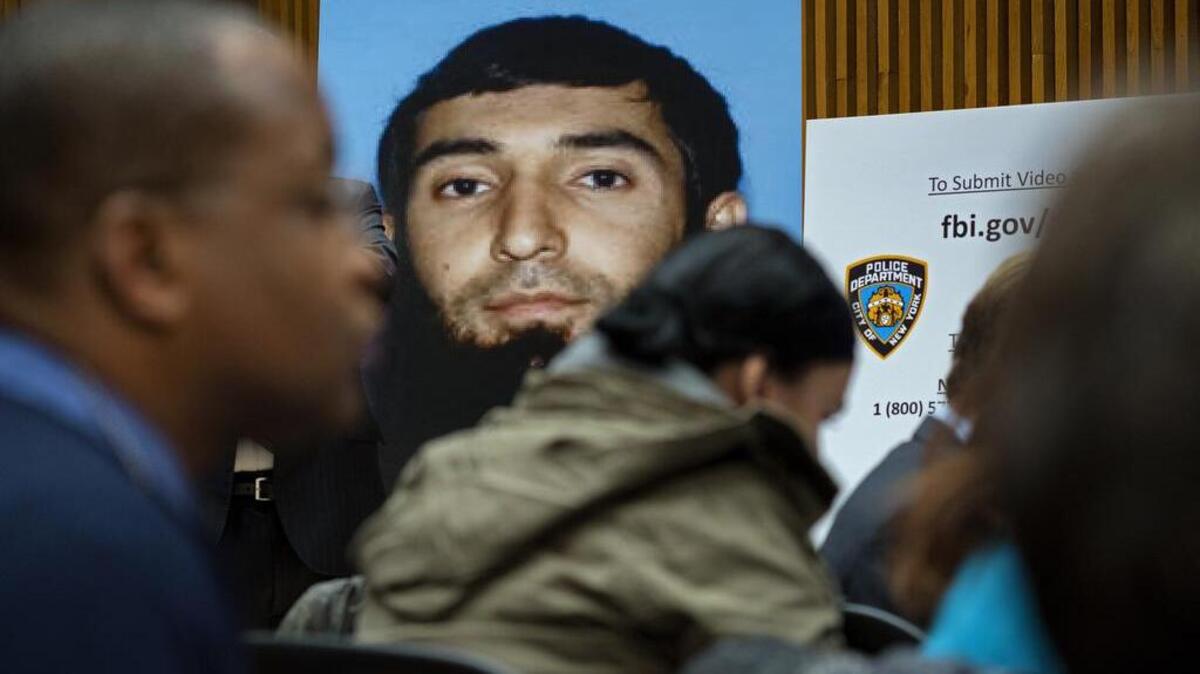 A photo of Sayfullo Saipov is displayed at a police news conference Wednesday. Saipov is accused of driving a truck on a bike path that killed several and injured others Tuesday near One World Trade Center in New York.
