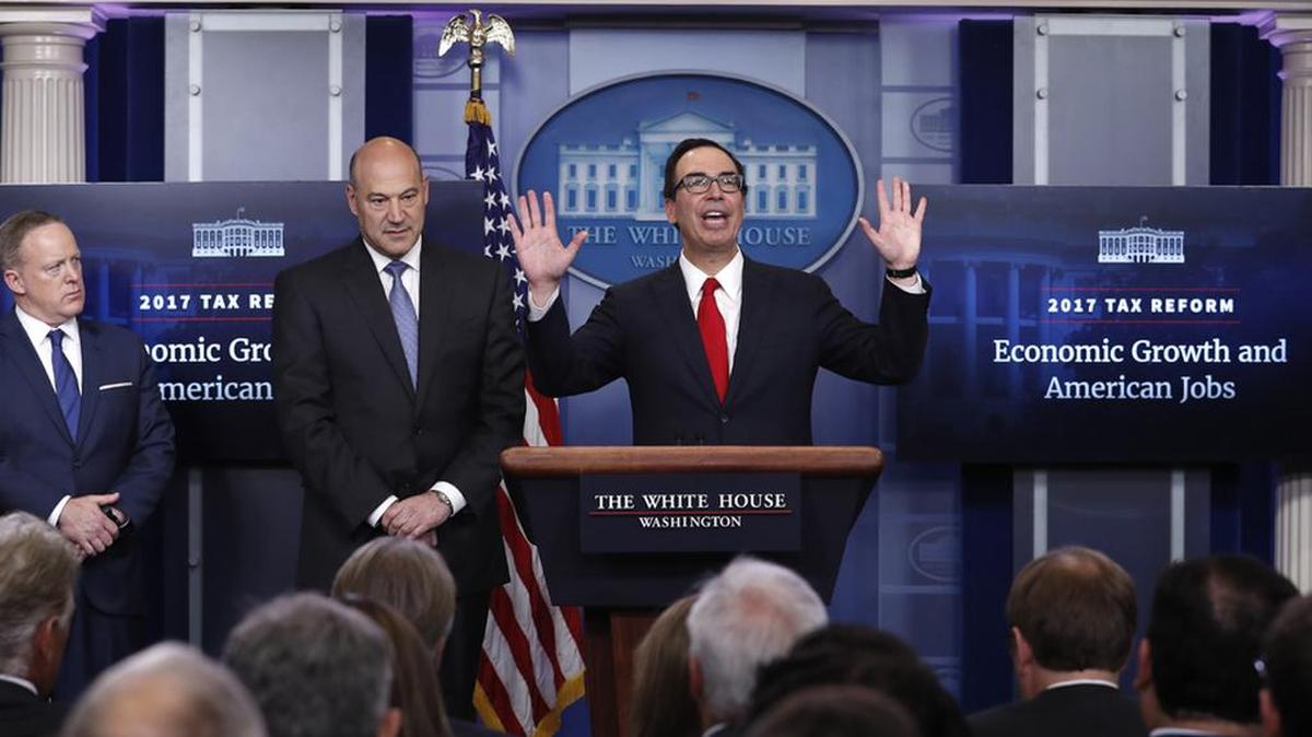 Treasury Secretary Steven Mnuchin, center, joined by National Economic Director Gary Cohn and White House press secretary Sean Spicer explains President Donald Trump’s tax plan on Wednesday.
