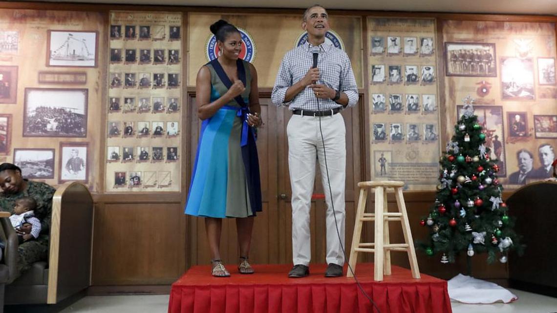 President Barack Obama, joined by first lady Michelle Obama, speaks during a Christmas day event to thank service members and their families at Marine Corps Base Hawaii.