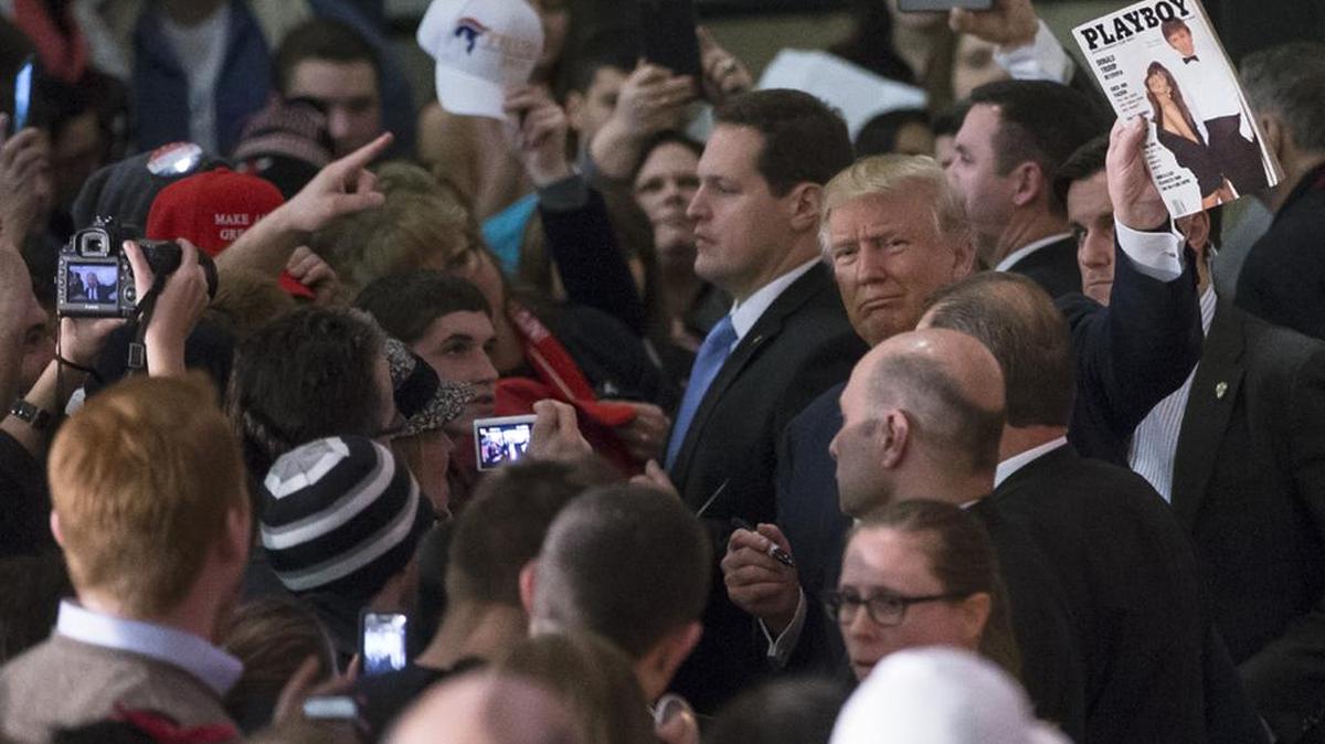 Republican presidential candidate Donald Trump shows off a copy of the March 1990 Playboy magazine that featured a cover story on him.
