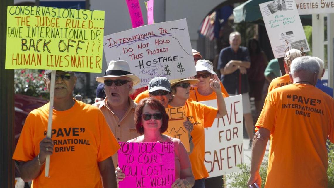 Coastal residents picket in front of the Coastal Conservation League office in Georgetown in support of International Drive, one of several highway projects the environmental group has gone to court to try to block.