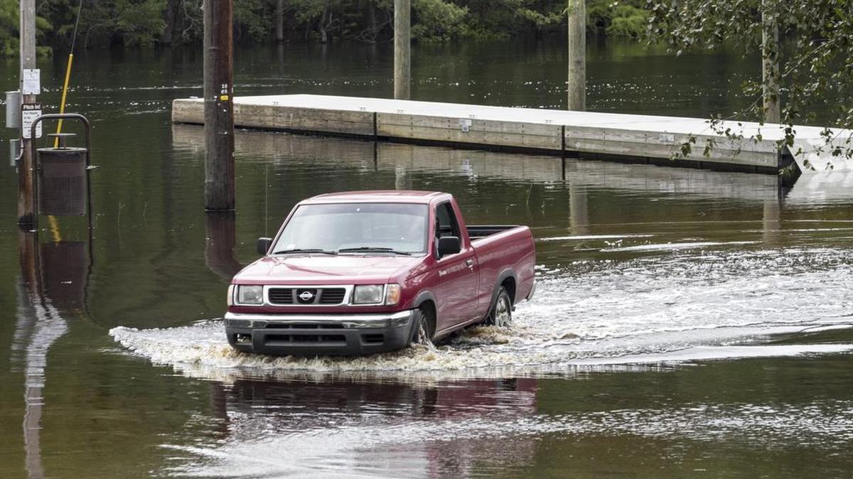 A truck drives through flood waters near the Waccamaw River outside Conway last week. The river was already less than a foot below flood stage a week and a half before Irma was expected to reach the United States.