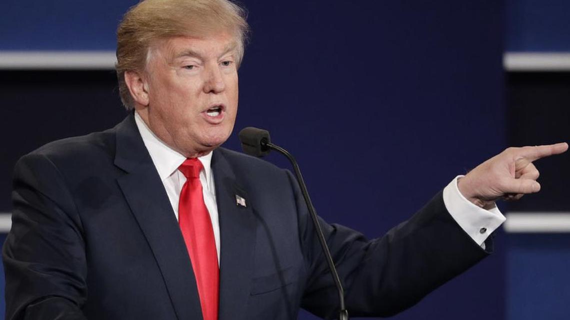 Republican presidential nominee Donald Trump points toward Democratic presidential nominee Hillary Clinton during their final debate on Wednesday.