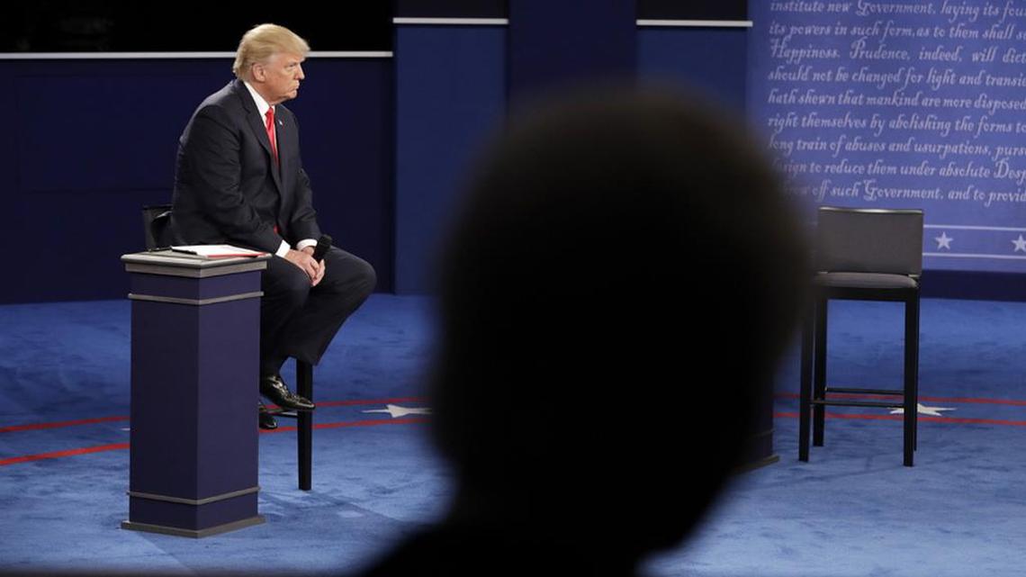Bill Clinton is in the foreground as Republican presidential nominee Donald Trump debates Hillary Clinton on Sunday.