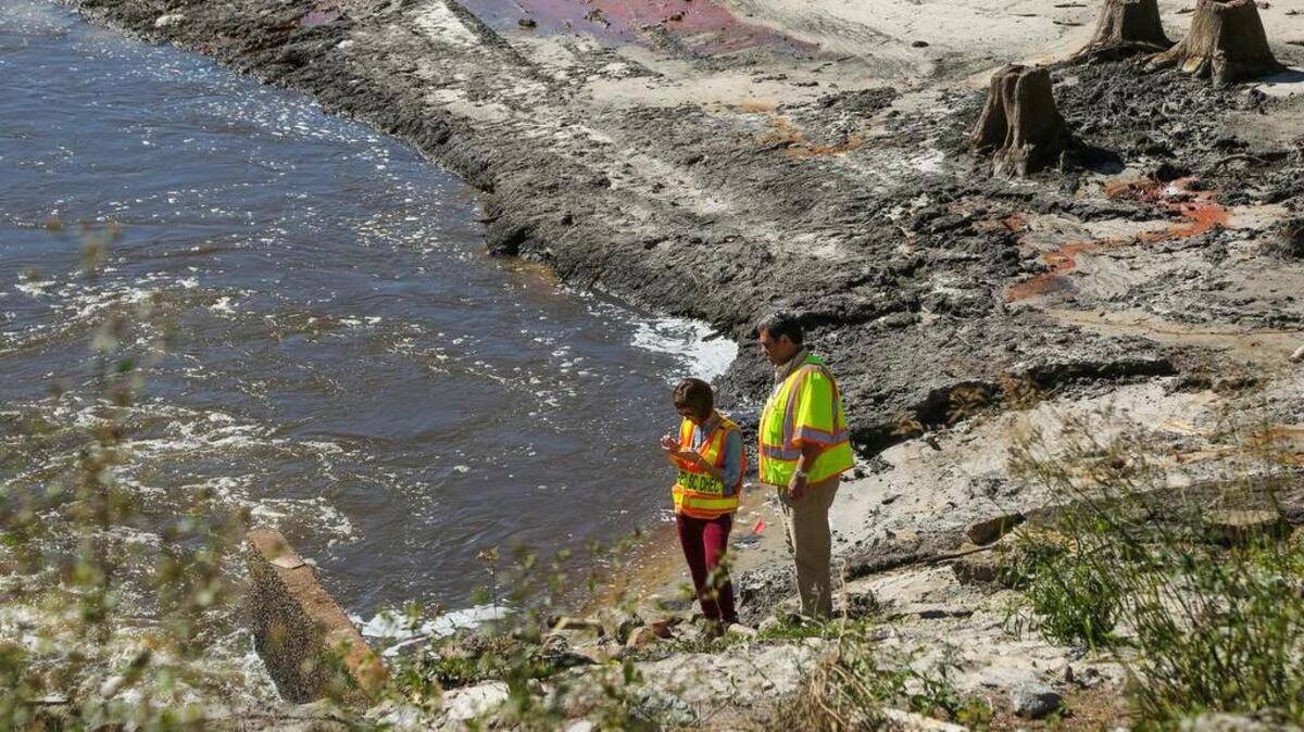 The Pine Tree Lake dam was one of several dams in the Gills Creek watershed that breached in a historic 2015 flood. Here, state inspectors examine the remains of the dam. It was not rebuilt.

