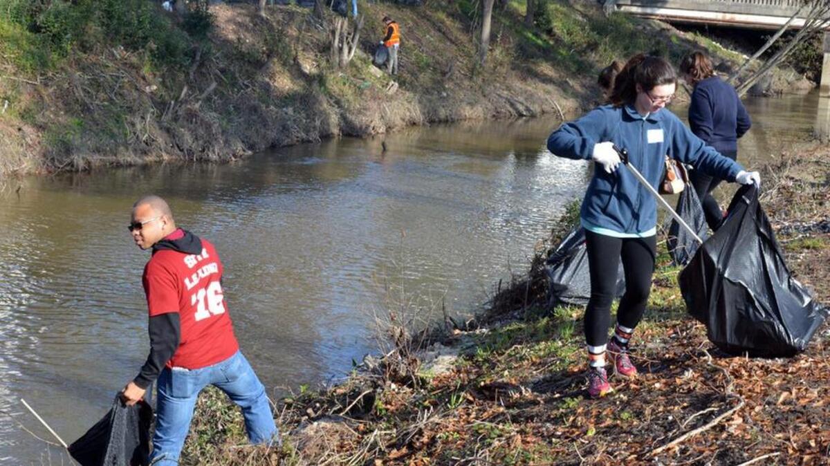 Volunteers can help contain the Zika virus by helping to control over-grown areas, cleaning up trash such as old tires and plastic containers, and helping people seal their homes so mosquitoes can’t get inside. Here, USC volunteers work earlier this year to clean up the Gills Creek area near Fort Jackson.