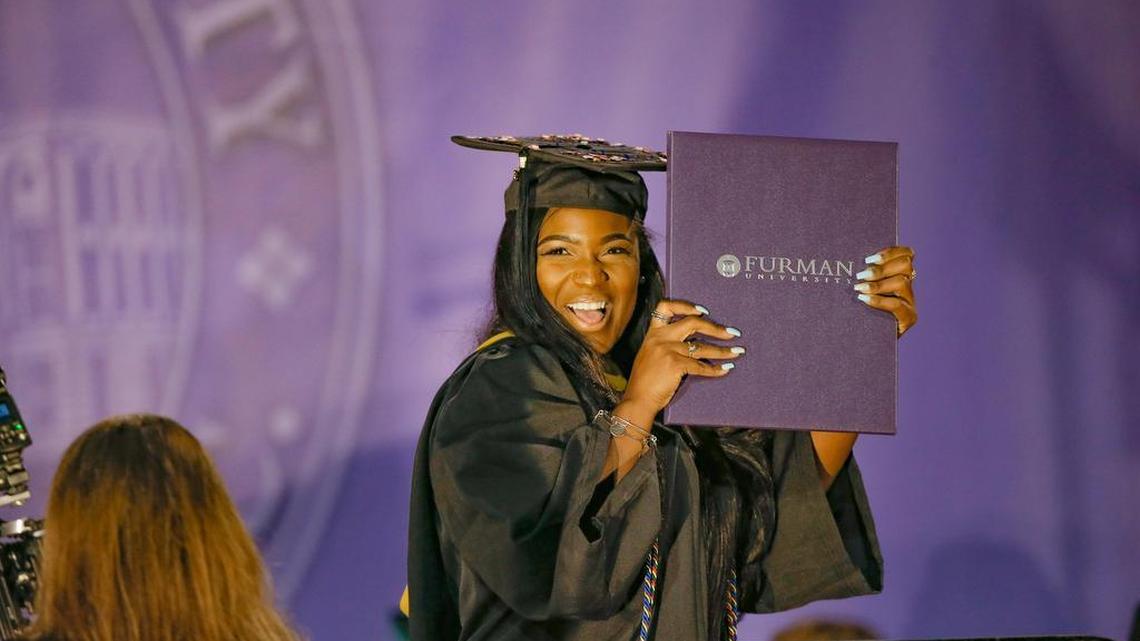 Alexis Glover of Belton shows off her chemistry degree at Furman University’s May graduation ceremony. Many people have begun to doubt whether college is worth the investment, at exactly the time that a college diploma is more valuable than ever.