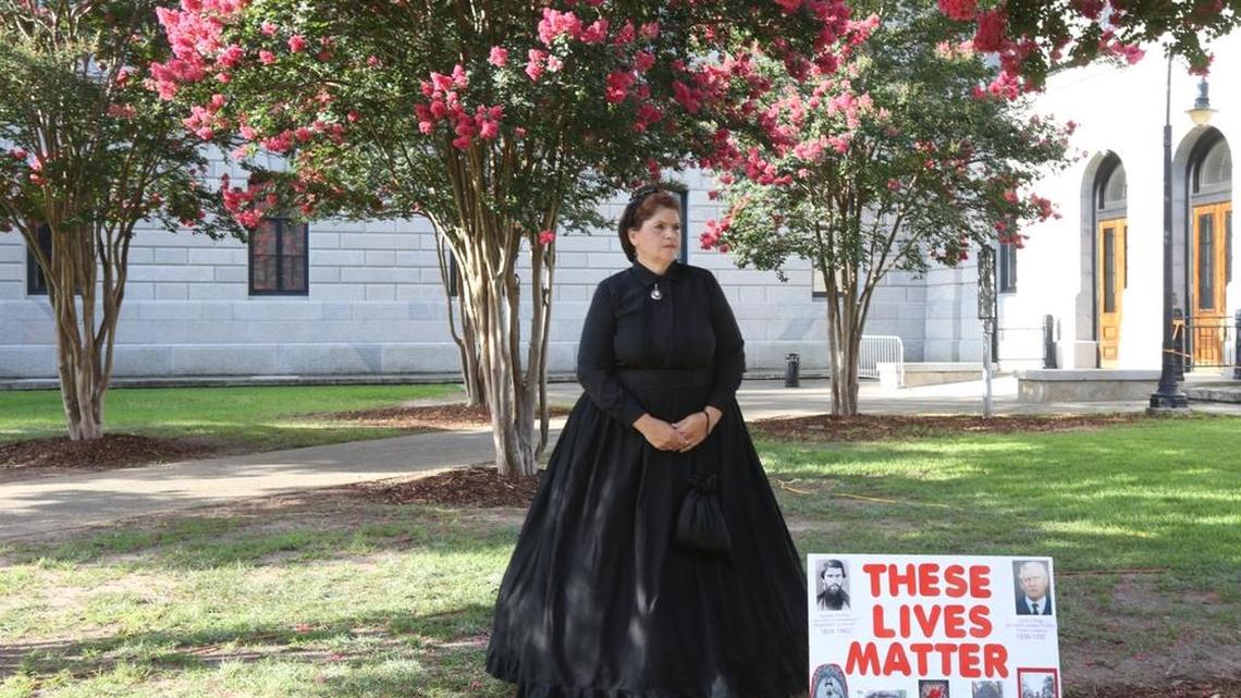 
Reenactors staged a memorial service for the Confederate flag as it was being removed from the State House grounds in July.

