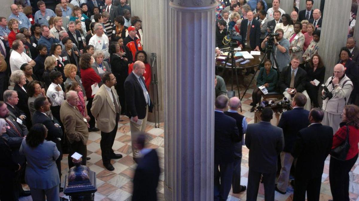 State employees rally at the State House to call for better pay.