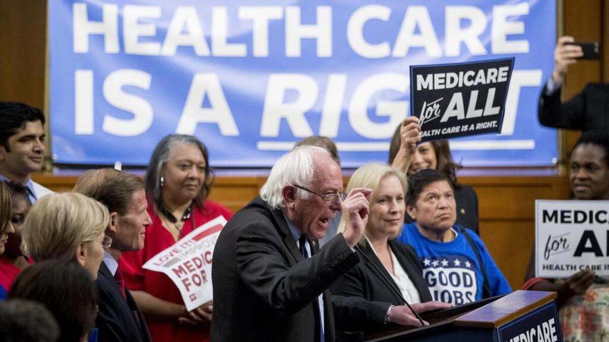 Sen. Bernie Sanders, I-Vt., center, accompanied by Sen. Kirsten Gillibrand, D-N.Y., center right, speaks at a news conference on Wednesday to unveil their Medicare for All legislation to reform health care.