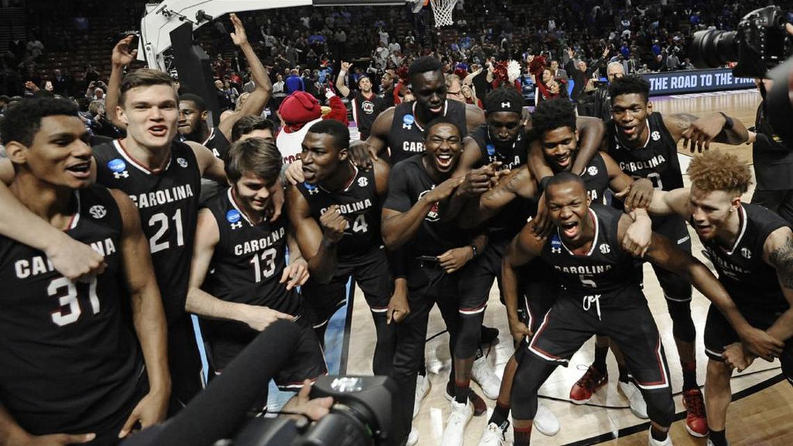South Carolina players celebrate after a second-round game against Duke in the NCAA men’s college basketball tournament Sunday in Greenville.
