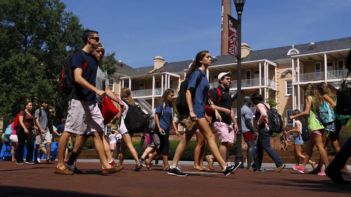 University of South Carolina students make their way past the Russell House on campus.