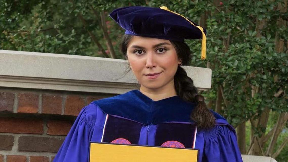 In an undated photo provided by Parastoo Amiri, Nazanin Zinouri poses for a photo with her doctoral degree from Clemson University.