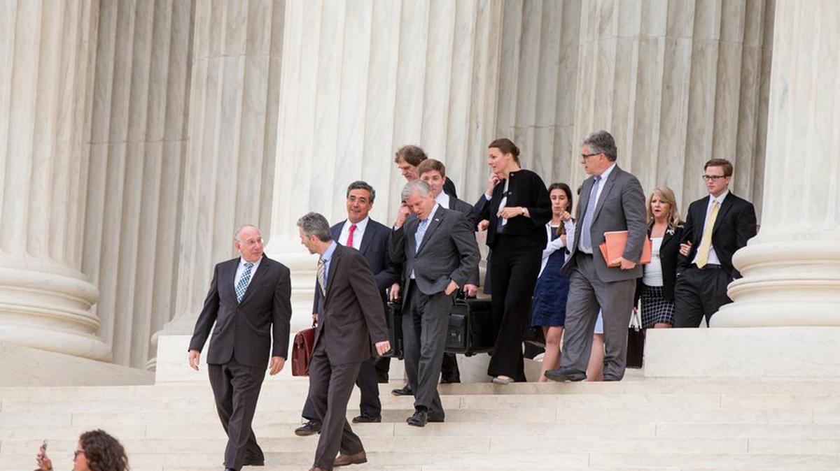 Former Virginia Gov. Bob McDonnell, fourth from left, walks out of the Supreme Court in April after oral arguments in his challenge to his corruption conviction. The court overturned the conviction on Monday.