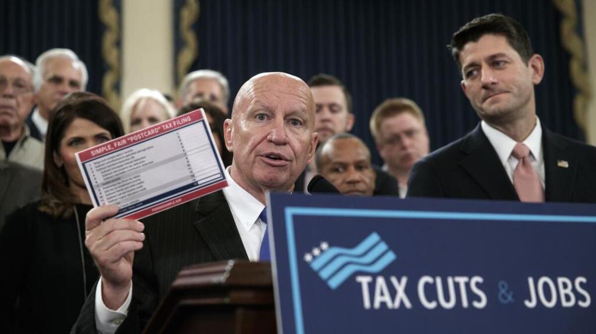 House Ways and Means Committee Chairman Kevin Brady, R-Texas, joined by Speaker of the House Paul Ryan, R-Wis., right, holds a proposed “postcard tax filing form” as they unveil the GOP’s far-reaching tax overhaul last week.