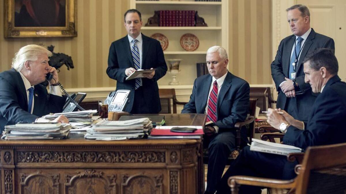In happier times: President Donald Trump accompanied by Chief of Staff Reince Priebus, Vice President Mike Pence, White House press secretary Sean Spicer and National Security Adviser Michael Flynn, speaks on the phone on Jan. 28 with Russian President Vladimir Putin.