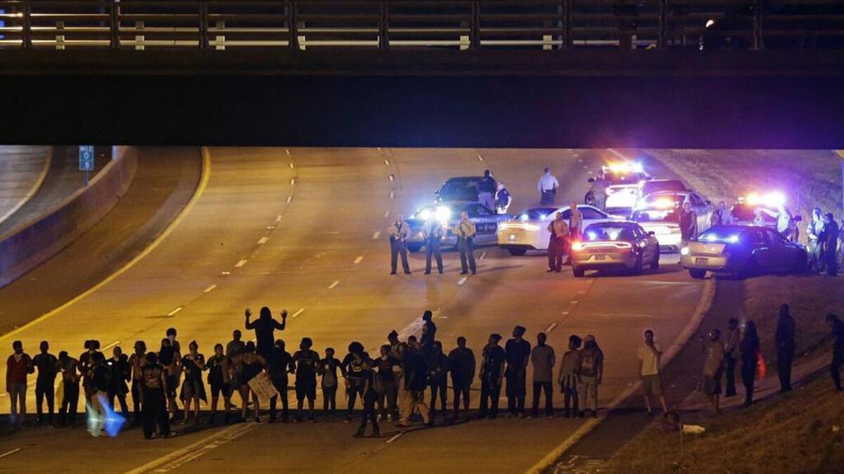 Police confront protesters blocking I-277 during demonstrations following Tuesday’s police shooting of Keith Lamont Scott in Charlotte.