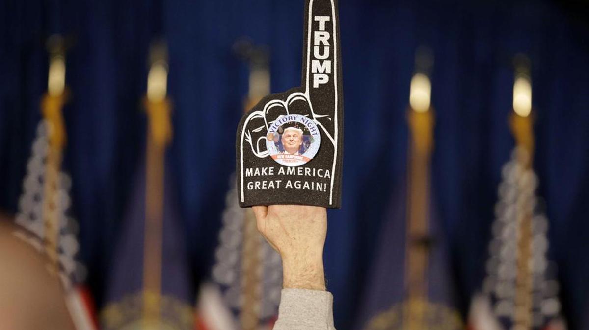 A supporter holds a foam finger sign promoting Republican presidential candidate Donald Trump at a primary night rally in Manchester, N.H.