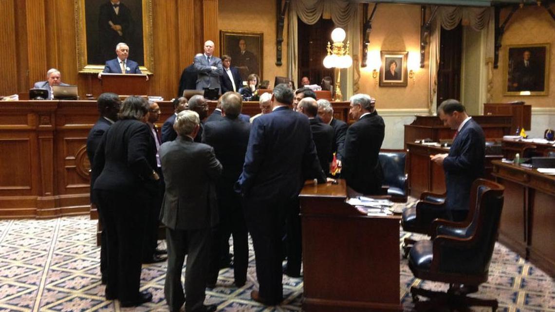 SC senators huddle during one of their debates of the roads legislation.