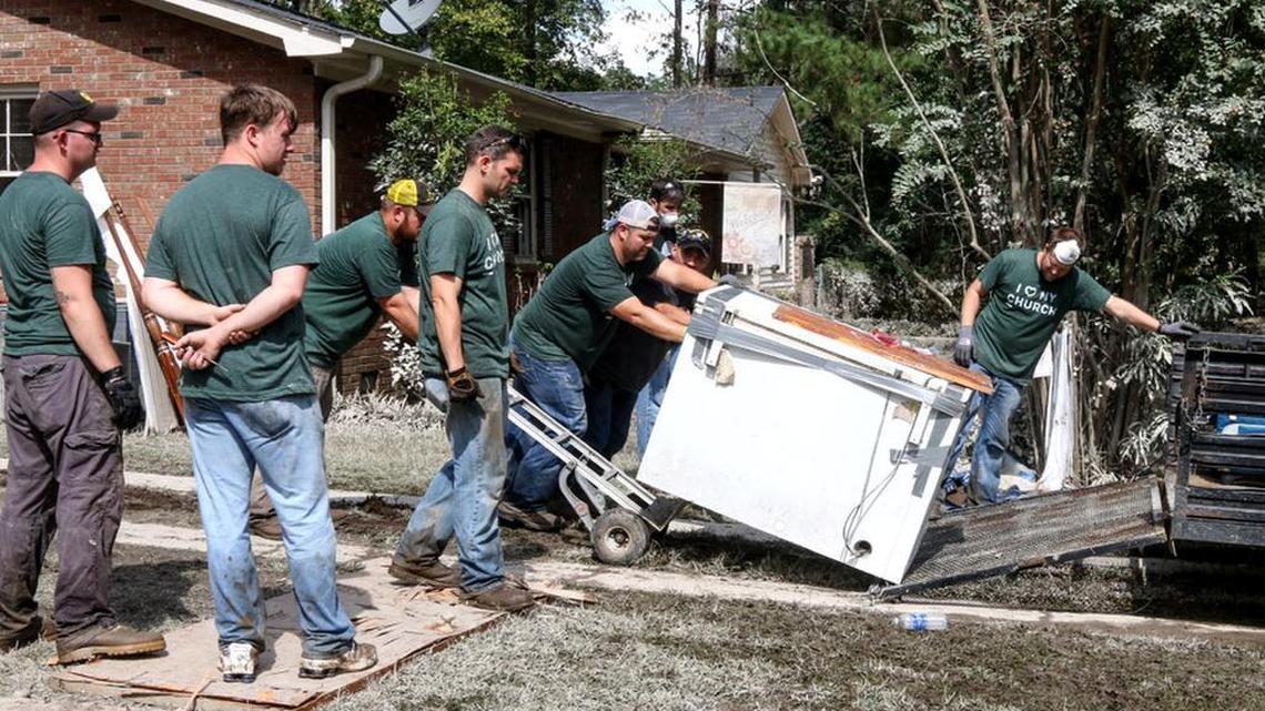 Volunteers from NewSpring Church help remove debris from a home in a flooded-out Columbia neighborhood.