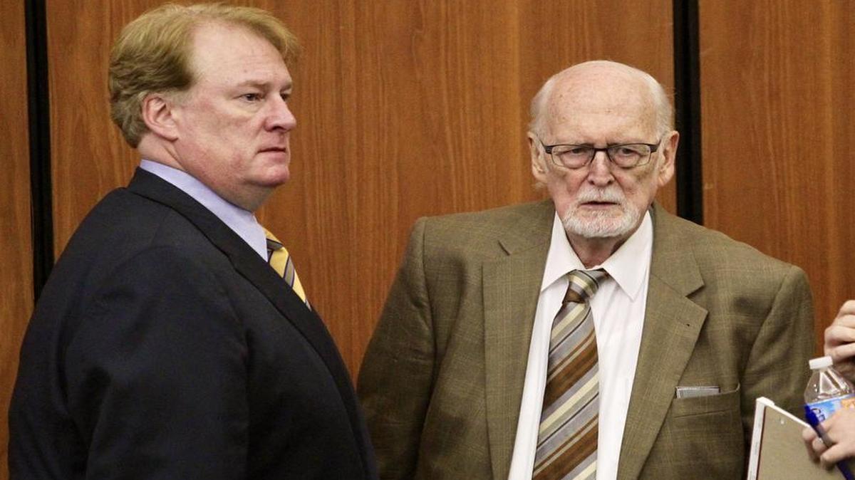 Indicted state Rep Rick Quinn, left, and his father, Richard Quinn Sr., talk during a break in Tuesday’s hearing.