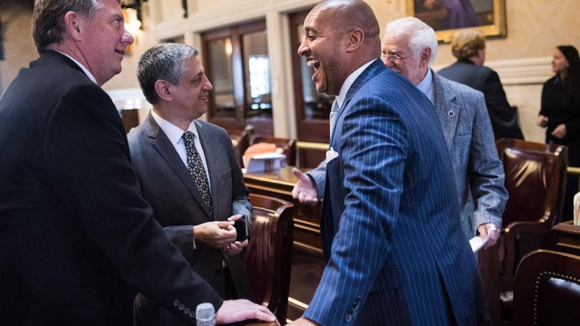 SC Rep Jim Merrill and one of his criminal defense attorneys, Rep Leon Stavrinakis, chat on the House floor on the first day of the 2016 legislative session with Reps Todd Rutherford and Dwight Loftis.