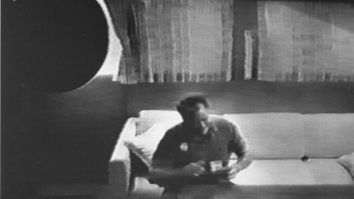 Then-Rep. Robert Brown thumbs through a cash payment from undercover lobbyist Ron Cobb on this 1990 FBI surveillance video.