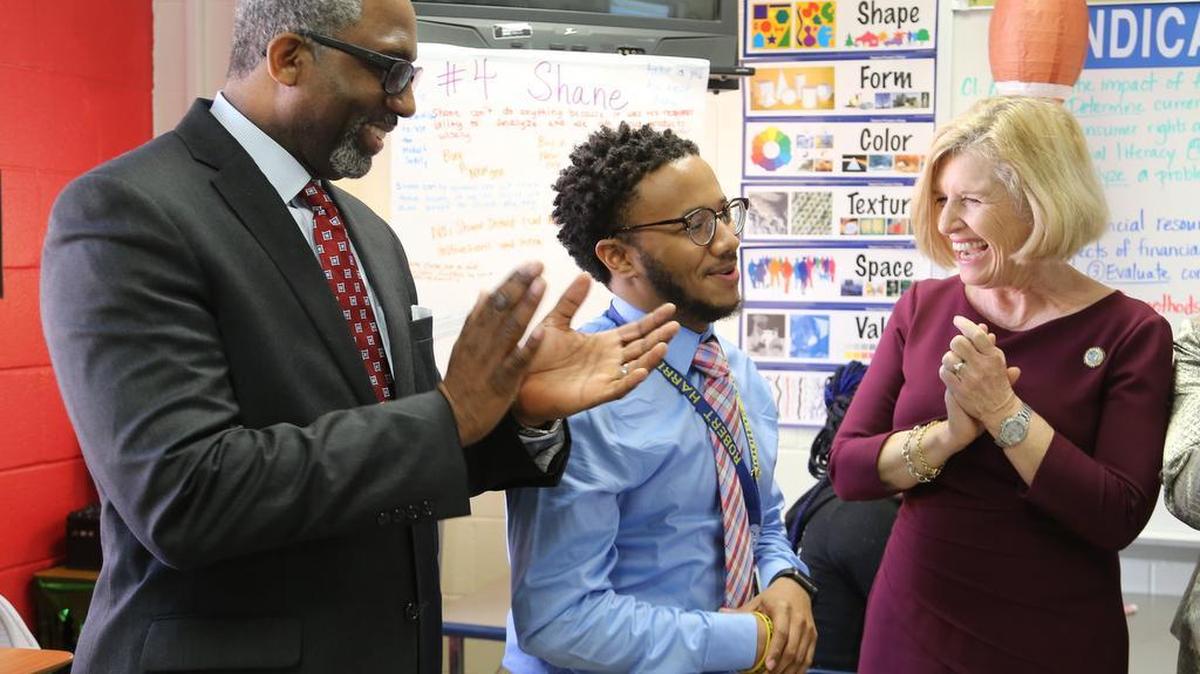 SC Education Superintendent Molly Spearman hopes voters will agree in November to let governors appoint future education chiefs. Here, she and Richland District 1 Superintendent Craig Witherspoon congratulate Hand Middle School teacher Robert Harris as a finalist for State Teacher of the Year.