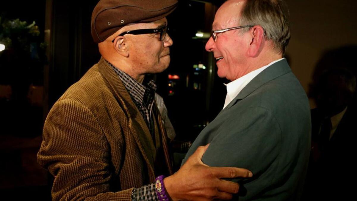 Ed McDowell and Howard Duvall hug after their victories in Tuesday’s Columbia City Council runoff election.