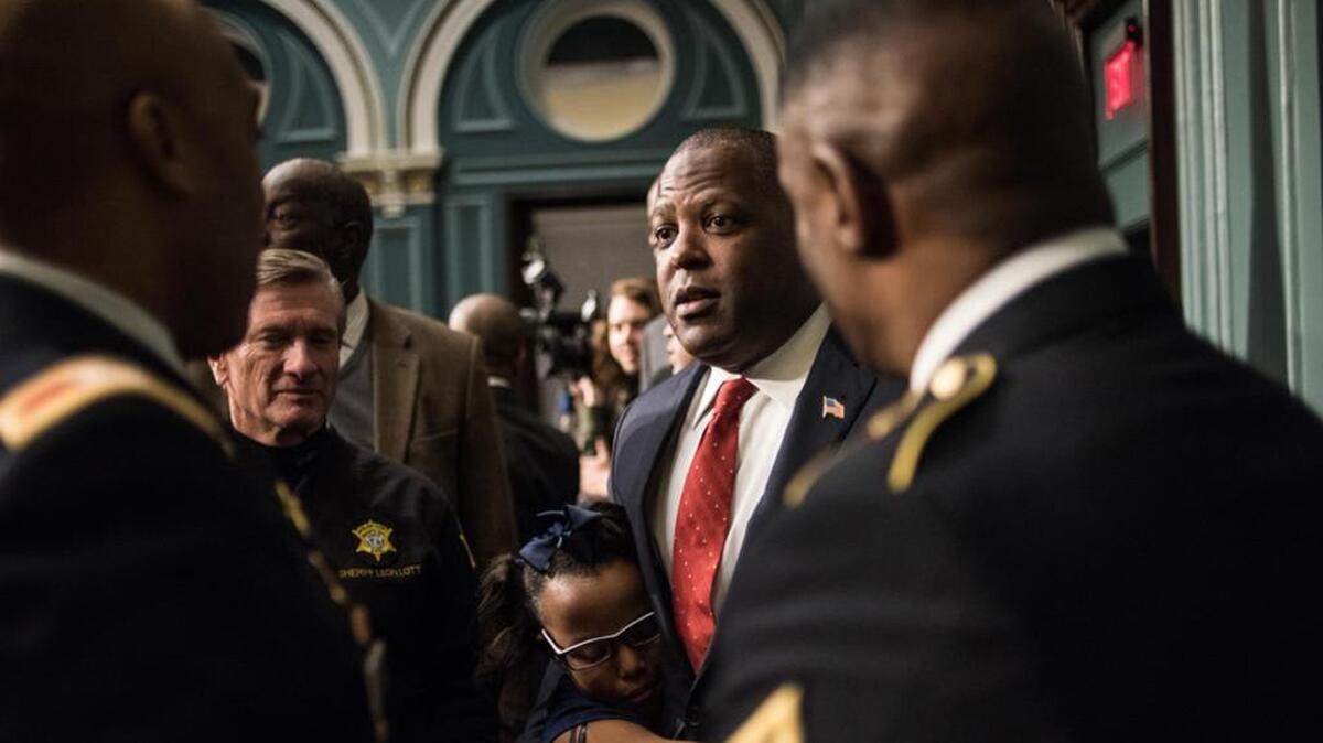 Columbia Mayor Steve Benjamin gets a hug from his daughter while talking with Col. James W. Ellerson, Richland County Sheriff Leon Lott and Command Sgt. Major Lamont Christian, after delivering the State of the City address in January.