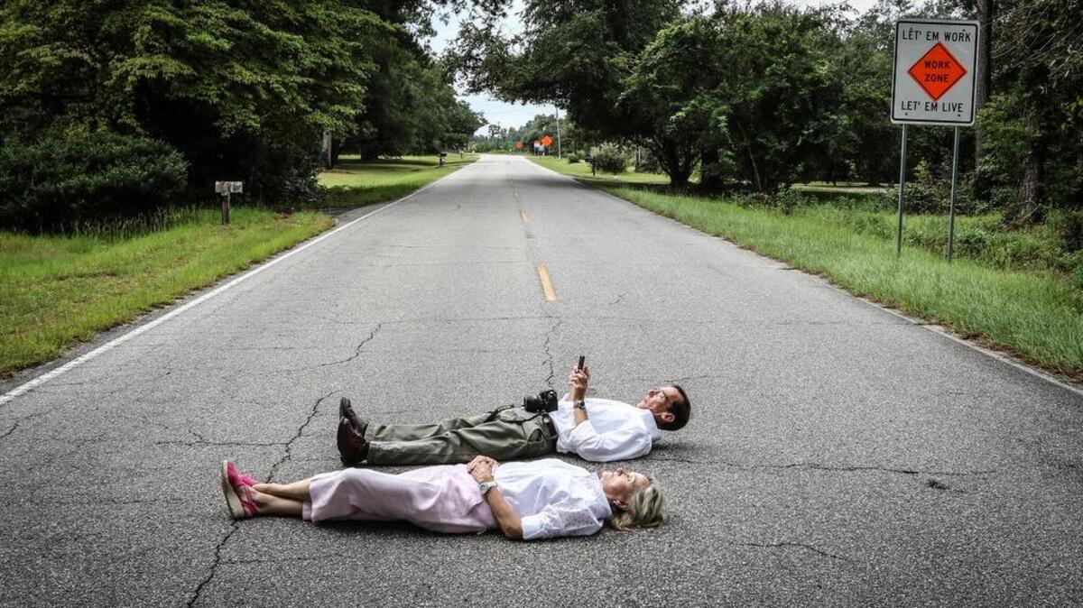 Opponents lie down in the middle of a Florence County highway at rush hour to demonstrate how wasteful it is for the State Transportation Infrastructure Bank to spend $250 million to widen it to four lanes.