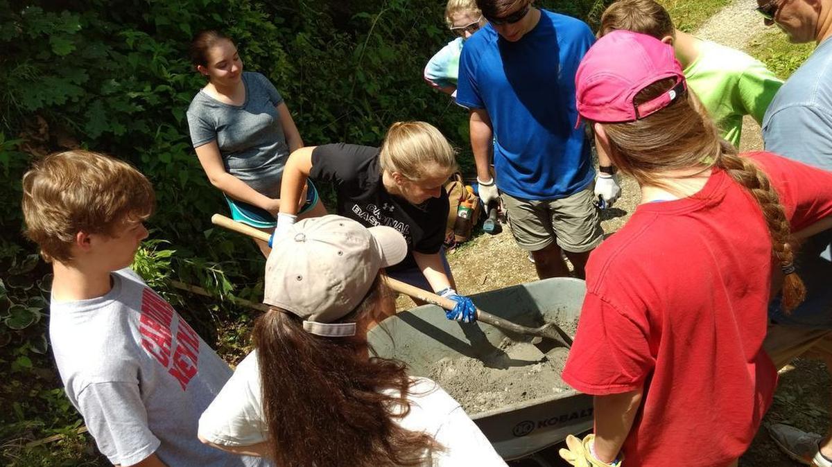 A week of worship, work and fellowship is a great escape from the incivility that now defines the body politic. High School students from Cardinal Newman School in Columbia and Meed Hall Episcopal School in Aiken prepare cement to brace a wheelchair ramp.