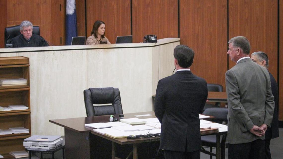 Suspended SC Rep Jim Merrill, with his hands behind him, appears at his bond hearing in December after being indicted on 30 corruption-related charges.