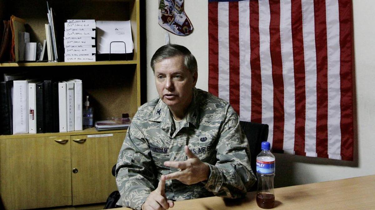 
US Sen Lindsey Graham talks to a reporter during a 2008 deployment to Kabul, Afghanistan.

