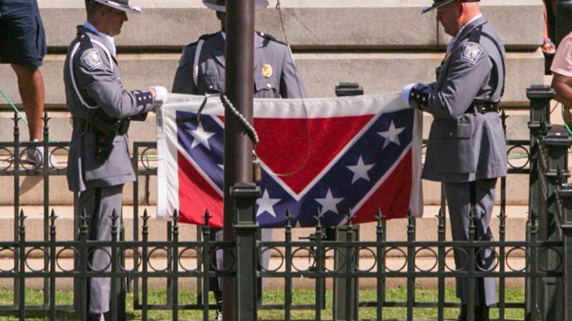 The SC Highway Patrol Honor Guard removes the $52 nylon Confederate flag from the State House grounds during a ceremony in July.