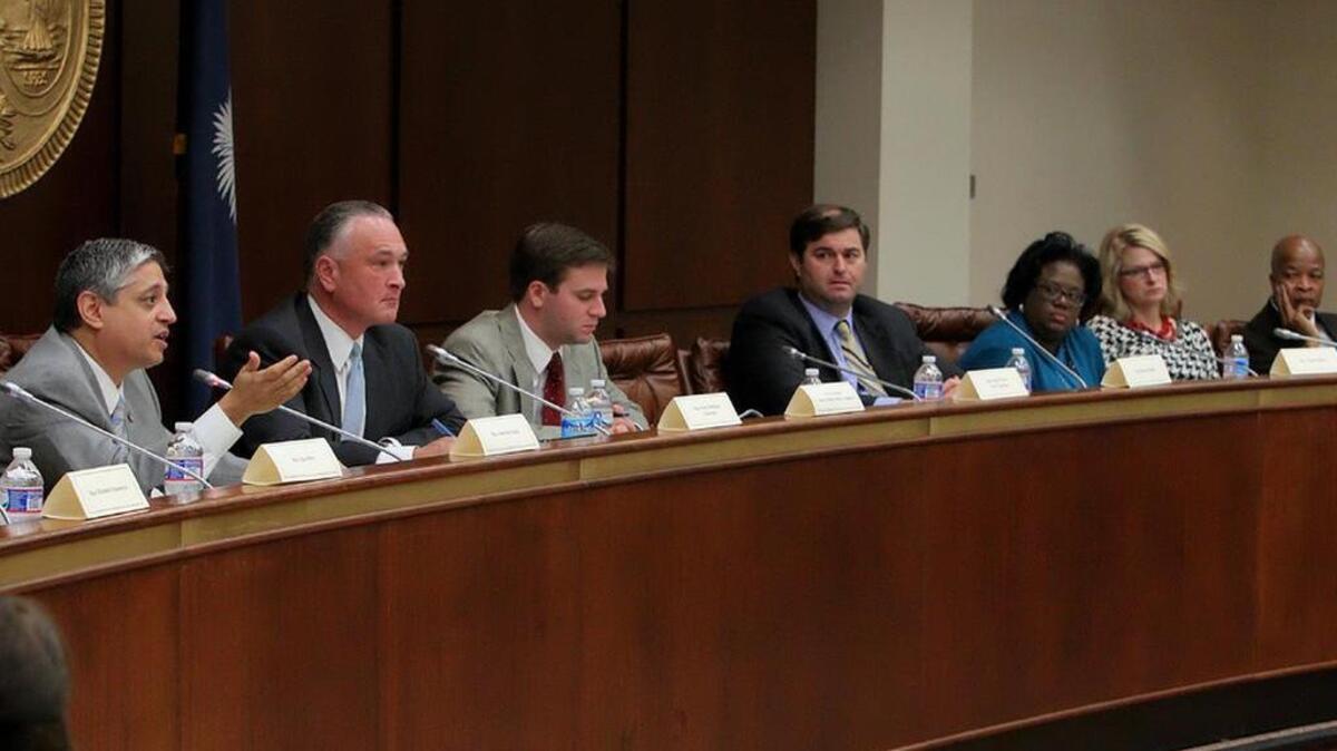 
Members of the House Ethics Committee hear testimony at a hearing on ethics law violations.
