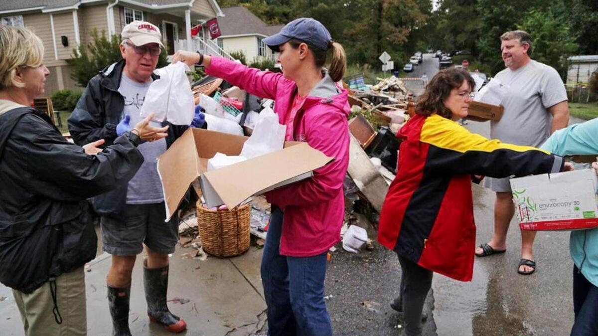 Volunteers with Mt. Hebron United Methodist Church hand out hot soup, homemade cookies and Gatorade to residents on Timberlane Drive as they cleaned up after the October floods.
