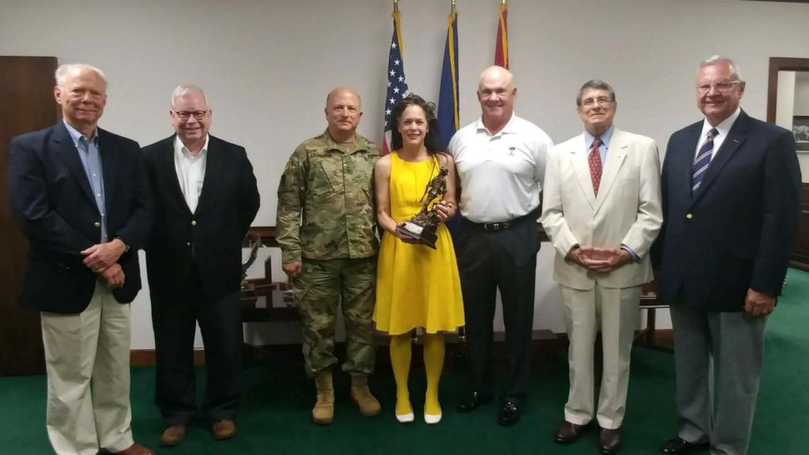 Cindi Scoppe poses for a photo in the adjutant general’s office with retired Brig. Gen. Tom McLean, retired Maj. Gen. John Bowen, Adjutant General Bob Livingston, Larry Crowson, executive director of the National Guard Association of South Carolina, retired Col. Barry Wingard and retired Brig. Gen. Herman (Butch) Kirven.