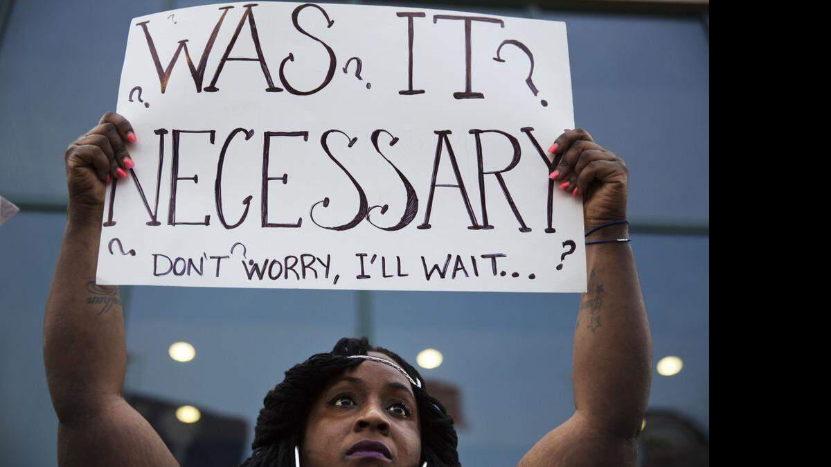 
Laquanda Multrie of Charleston holds a sign during an April 10 rally in North Charleston protesting the fatal police shooting of Walter Scott.
