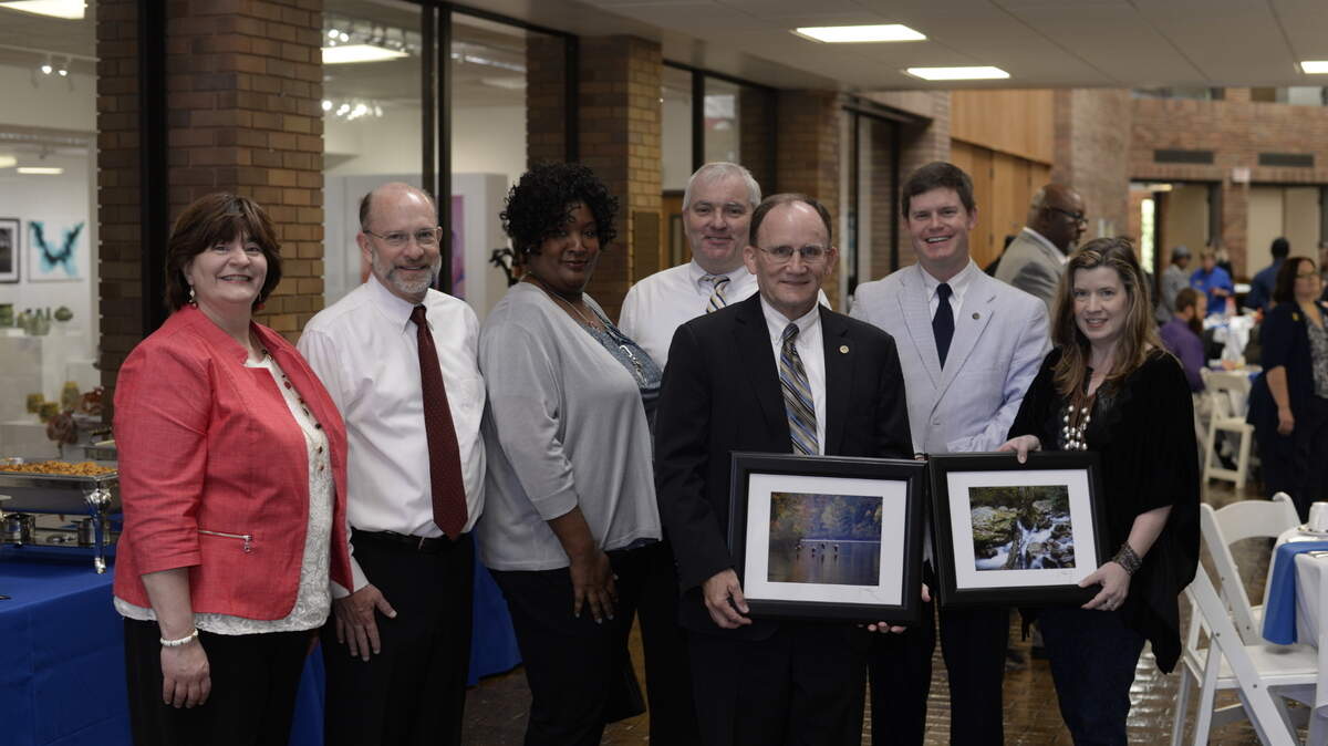 Bob Barrett, shown here on the center of the front row, was a retired dean of Lander University’s College of Business. This photo was taken at a Lander University graduation just before Barrett retired in 2017. Pictured from left to right: Drs. Judy Neufeld; David Mash; Holissa Wharton; David Slimmer; Lucas McMillan; Renee Love; Robert Barrett (front row center).