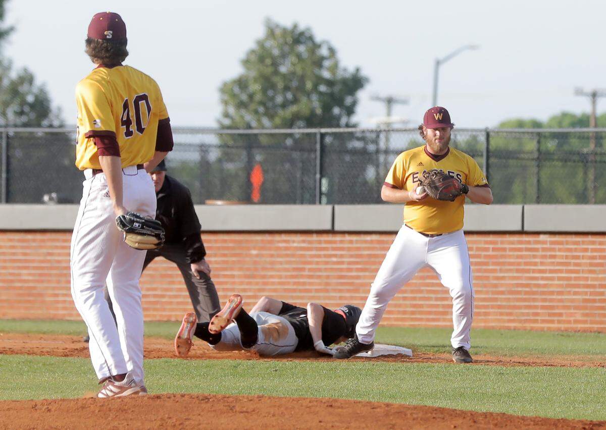 Winthrop’s Dillon Morton, right, tries to tag a USC player at first base.