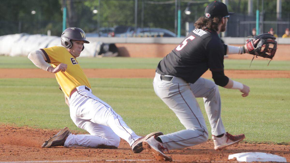 Winthrop’s Ethan Fewell slides into third base as USC’s Talmadge LeCroy waits for the ball from the pitcher.