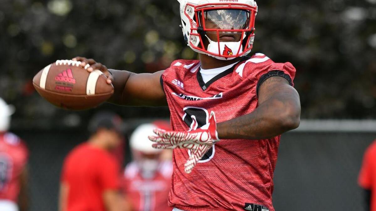 Louisville quarterback Lamar Jackson warms up before the start of the first open NCAA college football practice of the season, Monday, July. 31, 2017, in Louisville, Ky.